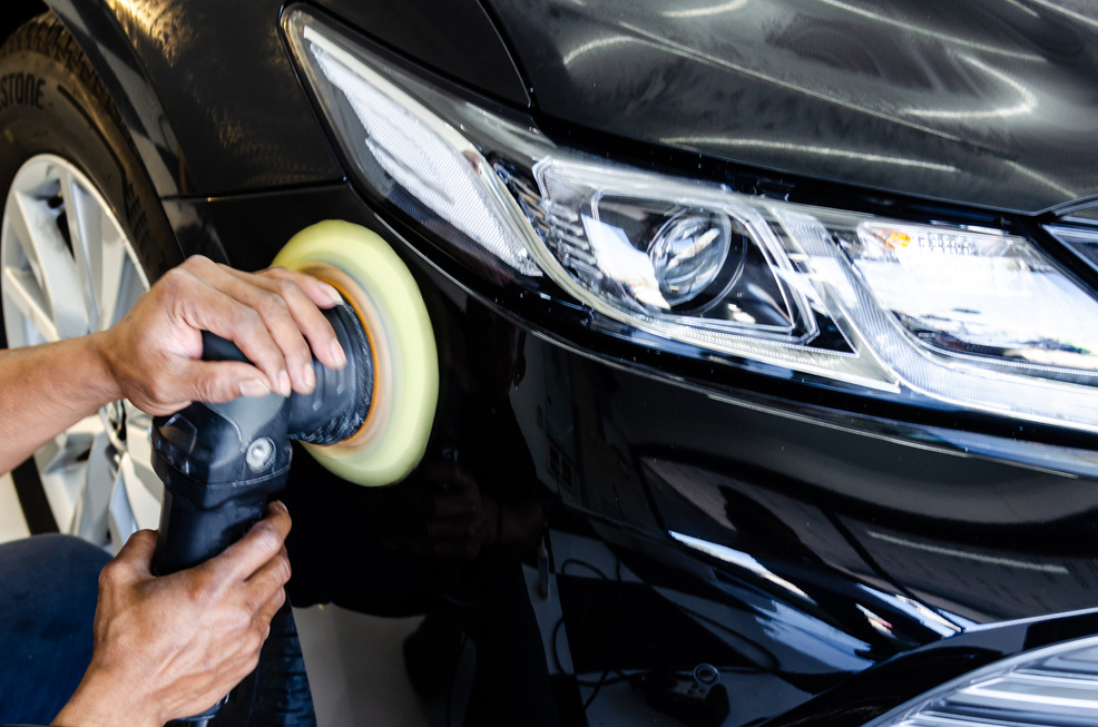 Hand Buffing a Car with a Polisher 